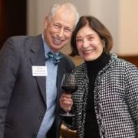 Chuck Schoenknecht and event guest smiling and looking at camera